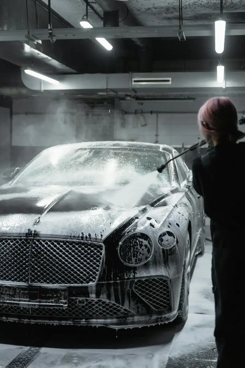 woman spraying a car with water