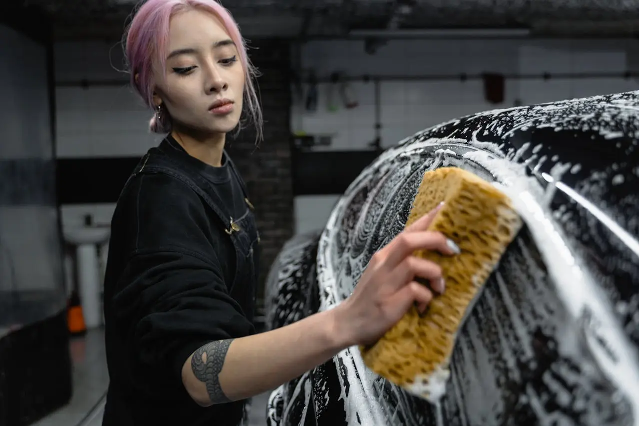 woman cleaning a car exterior